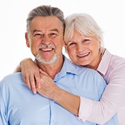 Older couple smiling together while wearing collared shirts