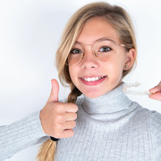 Invisalign Teen patient in Los Alamitos putting on aligners