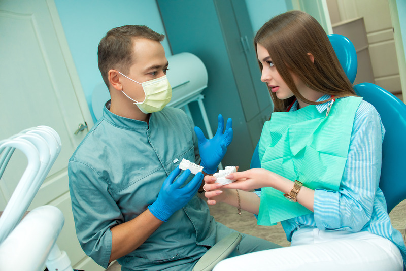 Patient talking to dentist at a dental checkup